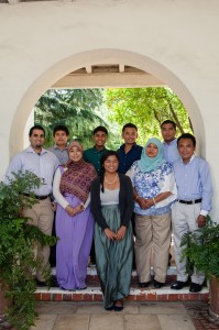 An image of Ariana Hussain, the article's author, in a family photo, consisting of nine individuals.