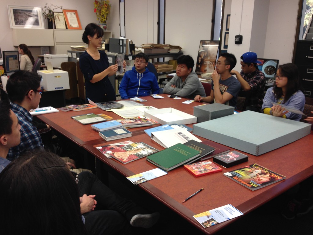 Thuy is showing a group of students some of the materials from their collections. Credit: Thuy Vo Dang