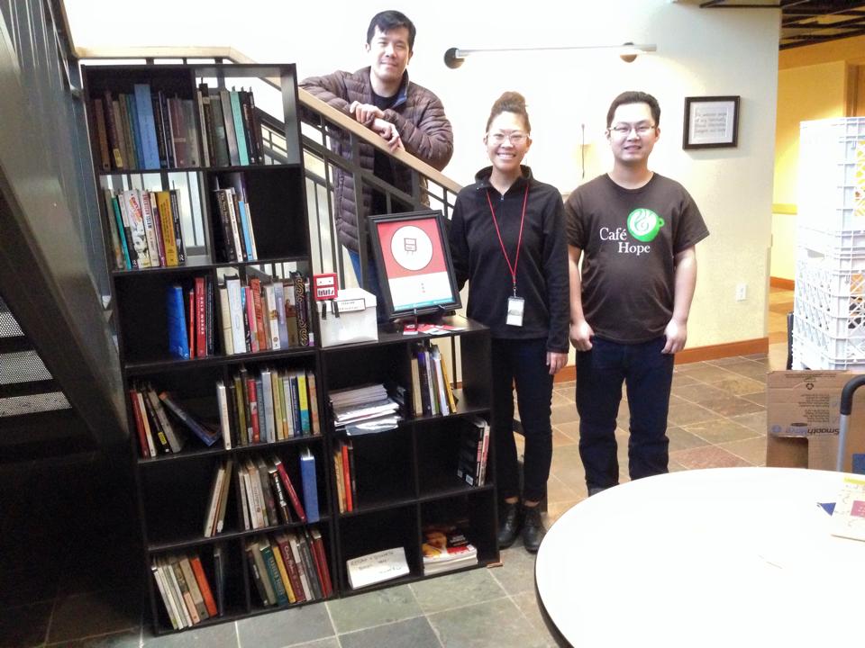 The API Flying Bookshelf, when it landed at Cafe Hope in January 2014. Pictured with curator Chris Woon (left) and 2 ACRS/Cafe Hope staff.