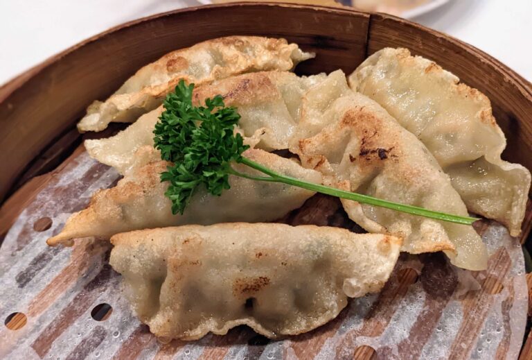 Fried dumplings in a bamboo steamer