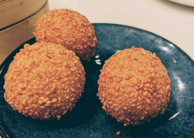Sesame balls on a blue plate.