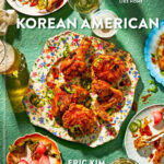Cover of the cookbook "Korean American." Floral plate of chicken, green background.